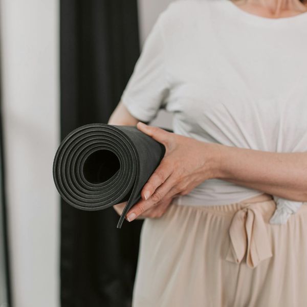 Close up of female hands holding a yoga mat